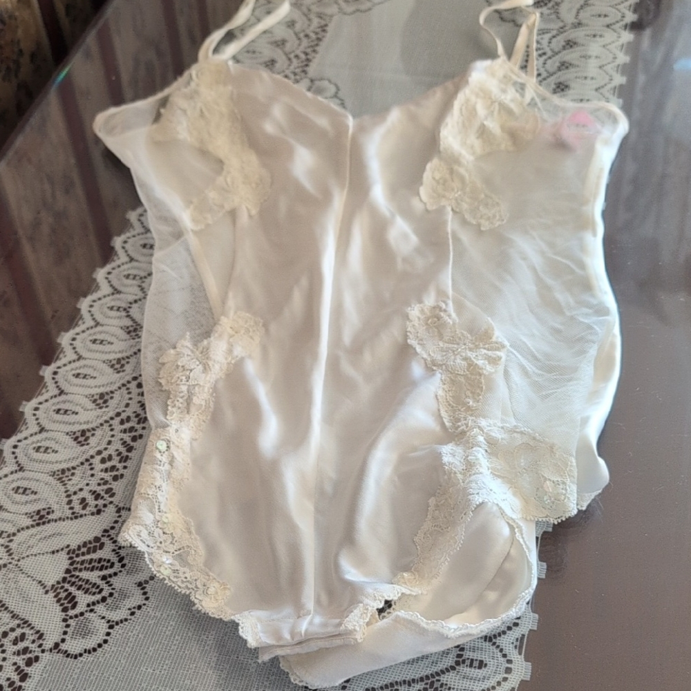 A Cream Colored Teddy.  Front And Back Are Satin With Mesh See Through Sides.